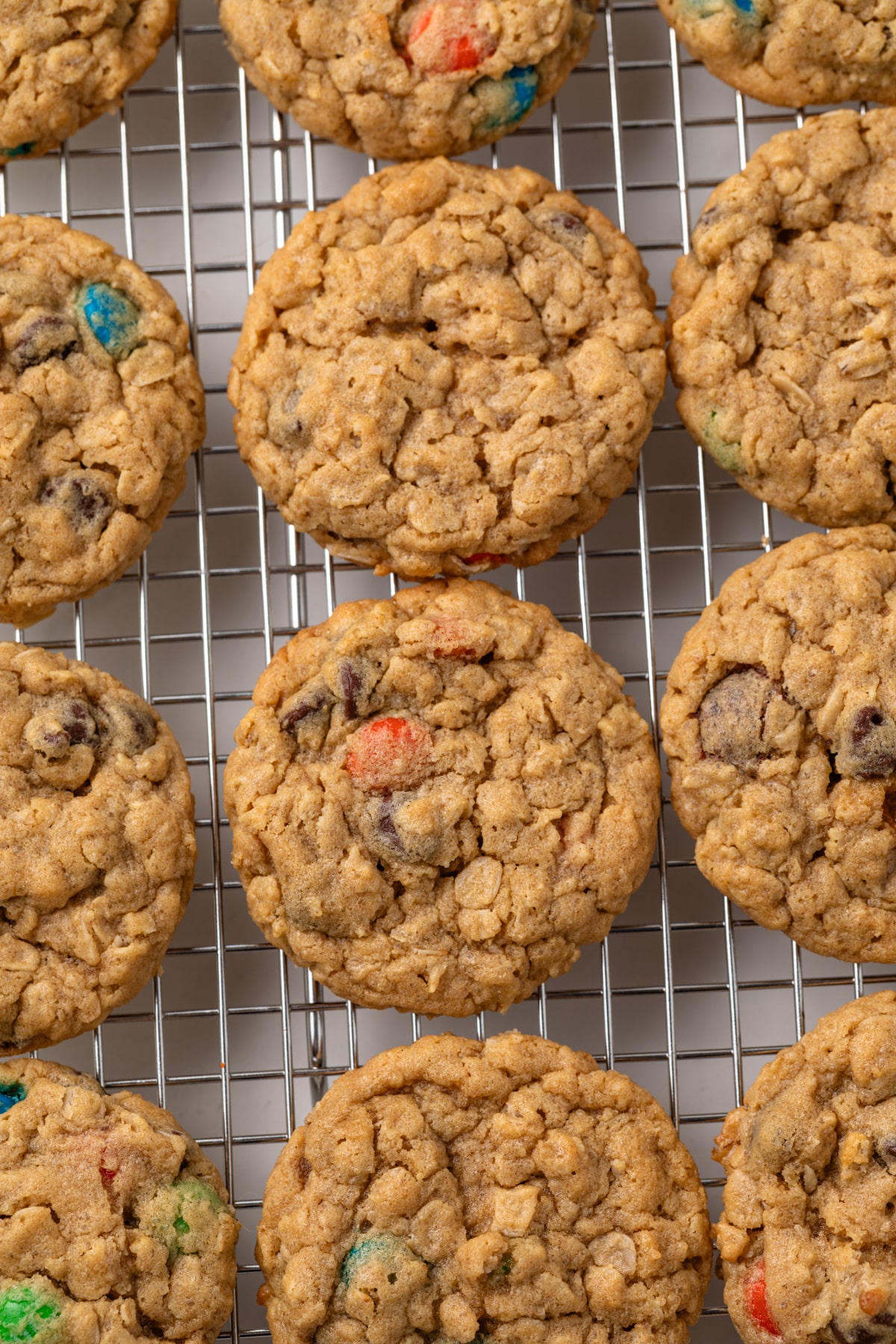 Overhead of monster cookies on a wire rack.