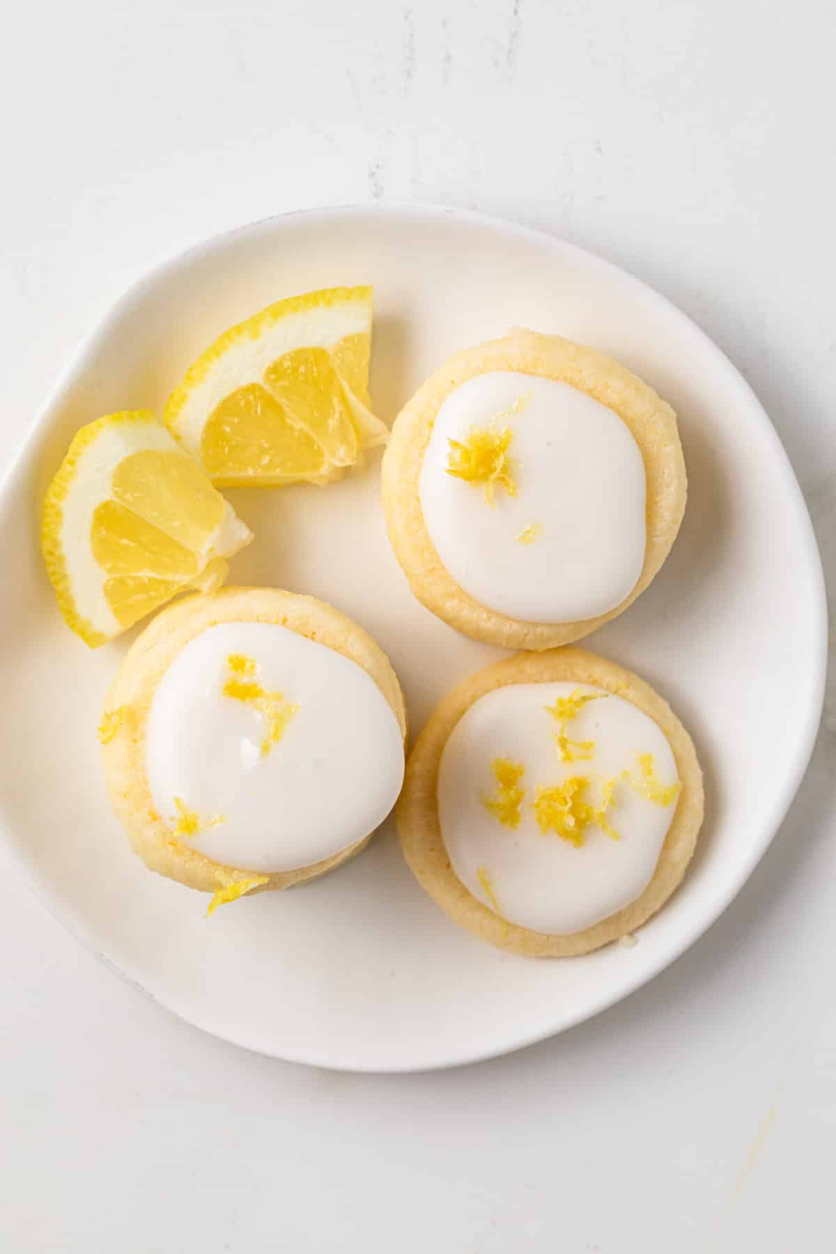 Overhead of lemon meltaway cookies on a white plate.