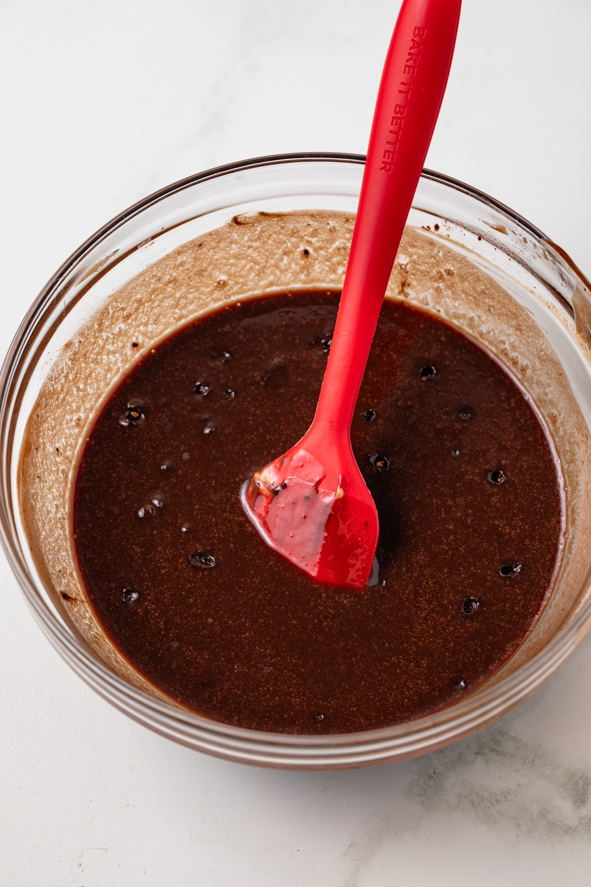 Melted chocolate in glass bowl.