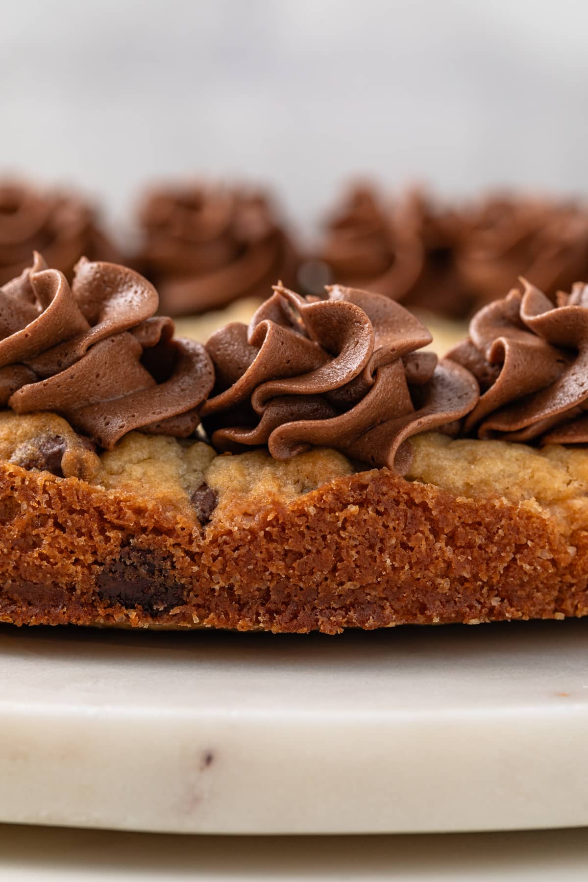 Chocolate frosting piped on cookie cake.