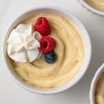 Overhead of vanilla pudding in white bowl.