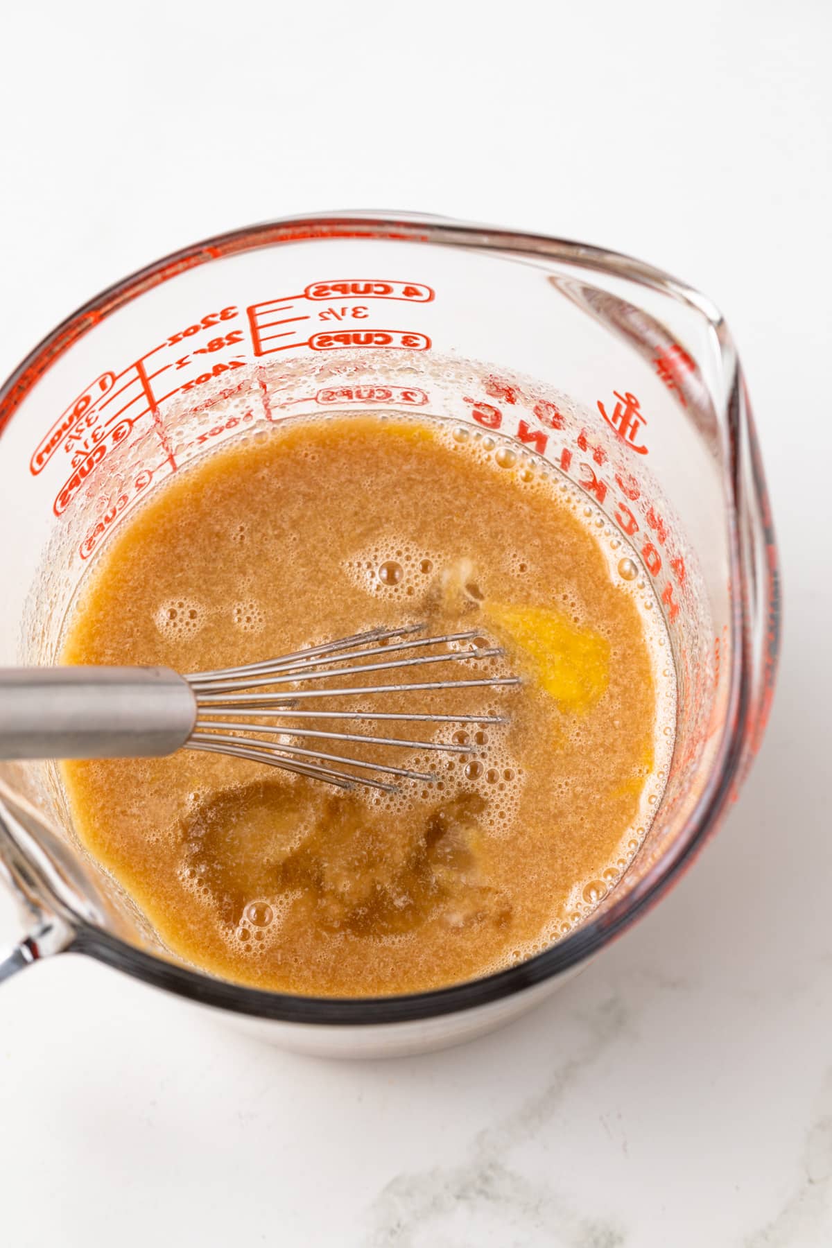 Wet ingredients mixed in liquid measuring cup.