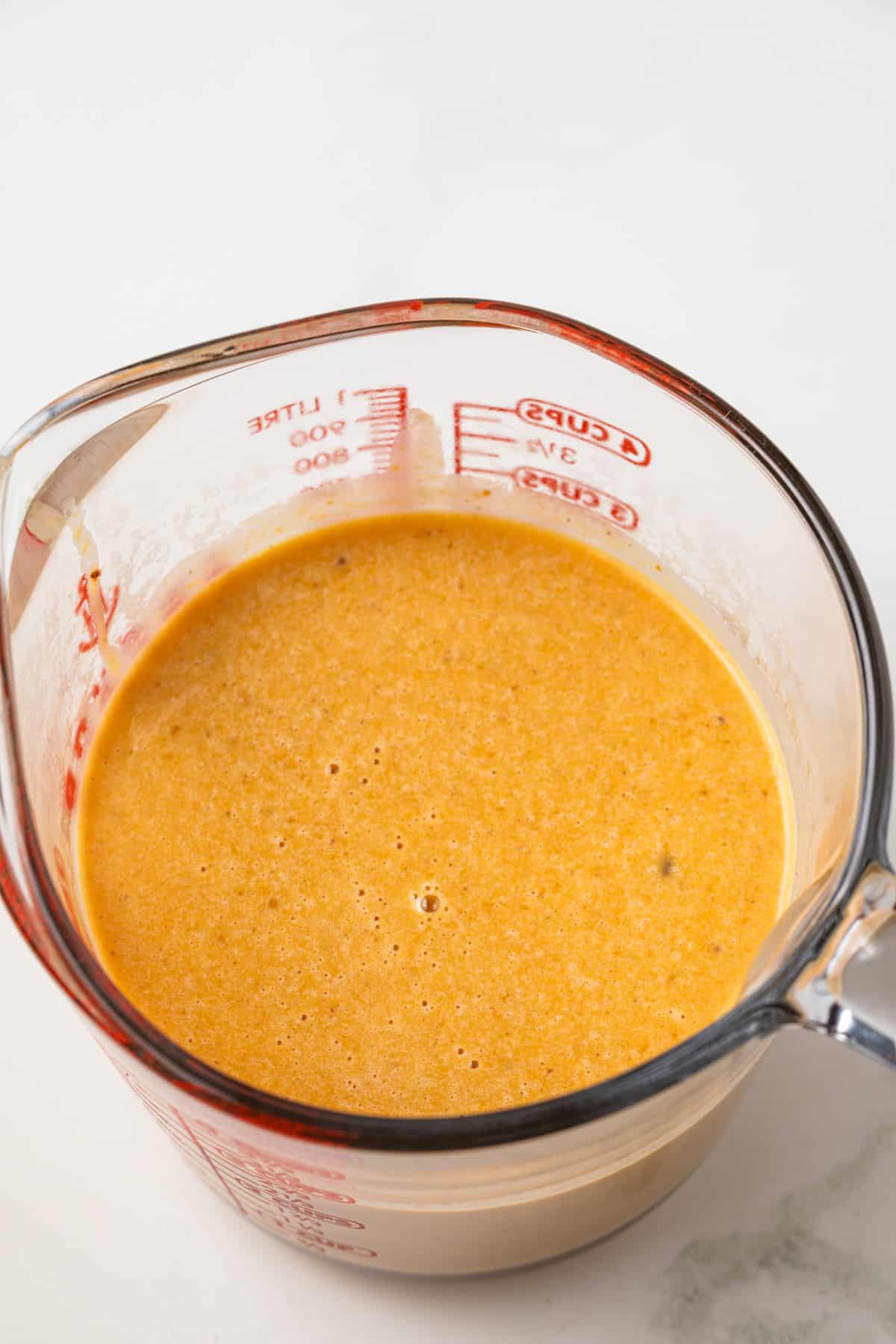 Custard mixture in liquid measuring cup.