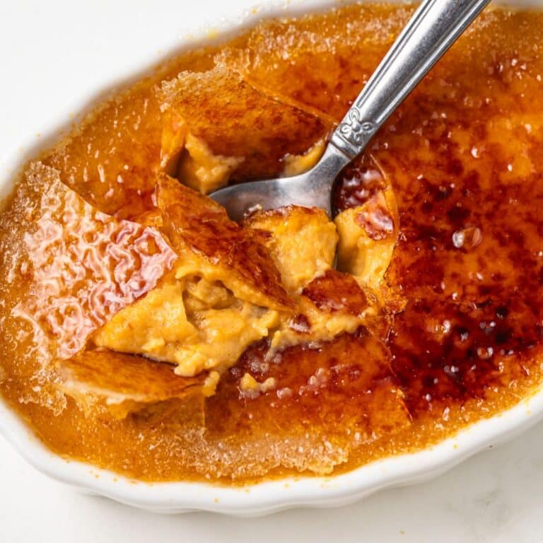 Spoon scooping out pumpkin creme brulee.