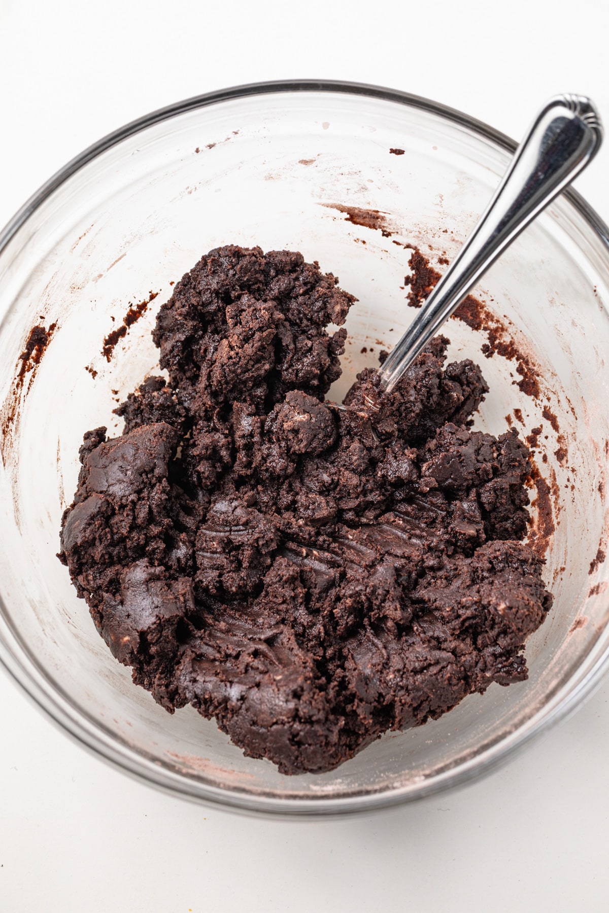 Chocolate tart dough in glass bowl.