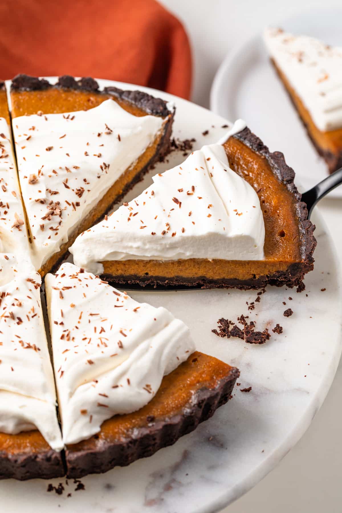 Slice of chocolate pumpkin tart being pulled away.