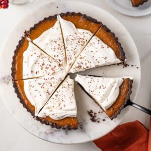 Overhead of sliced chocolate pumpkin tart.