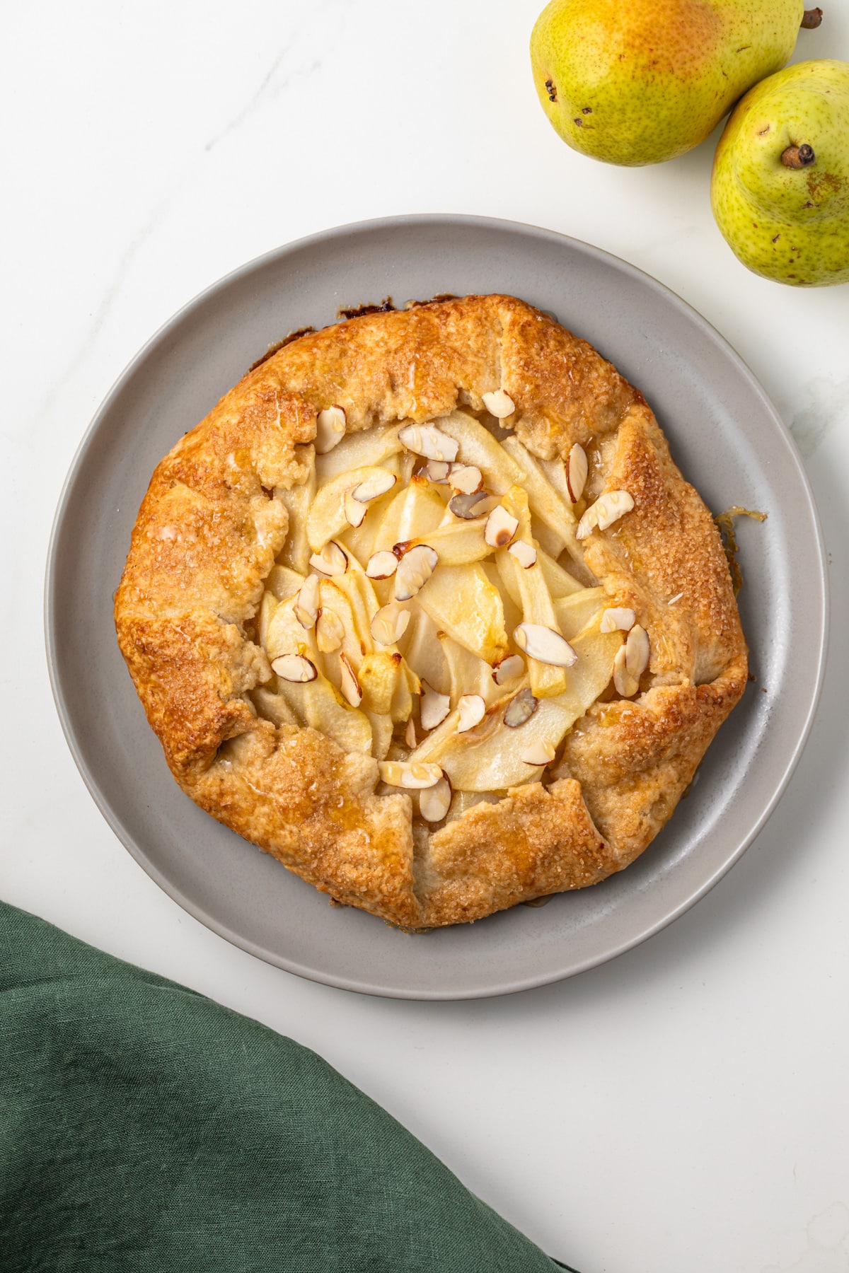 Pear almond crostata on a plate.