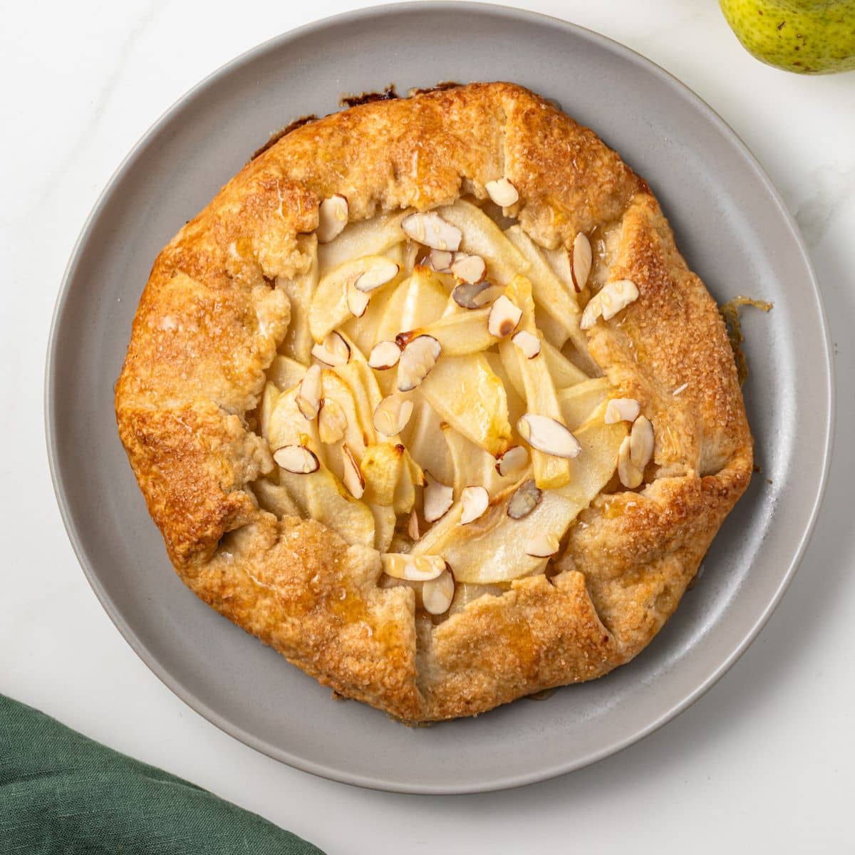 Pear almond crostata on a plate.