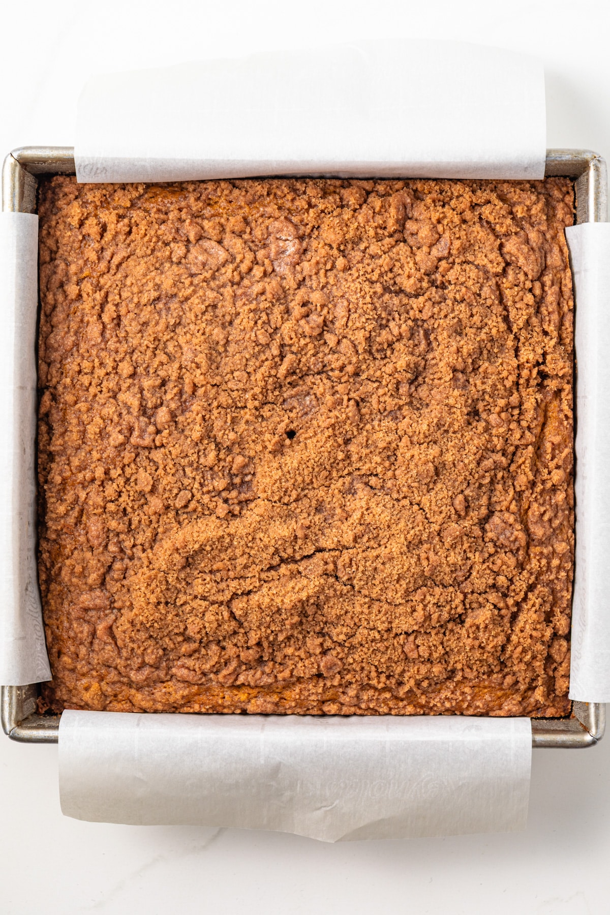 Pumpkin coffee cake in a square pan.