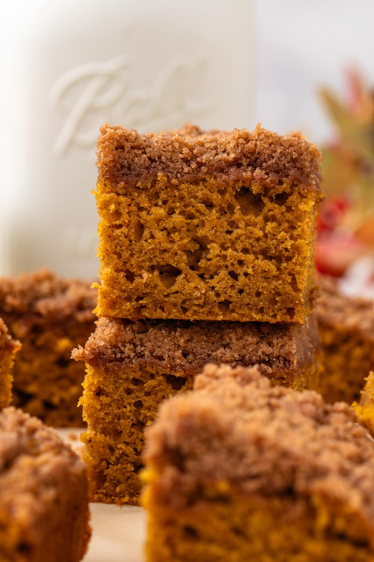 Close up of two pumpkin coffee cake squares stacked.