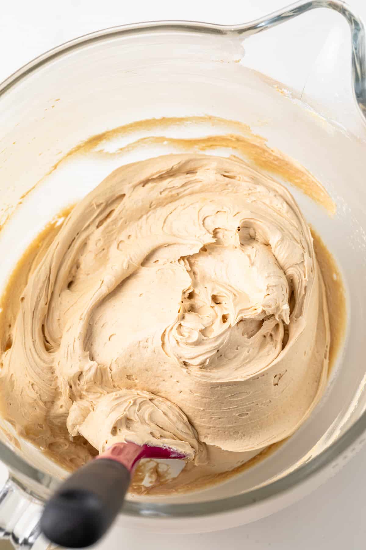 Coffee frosting in a glass bowl.