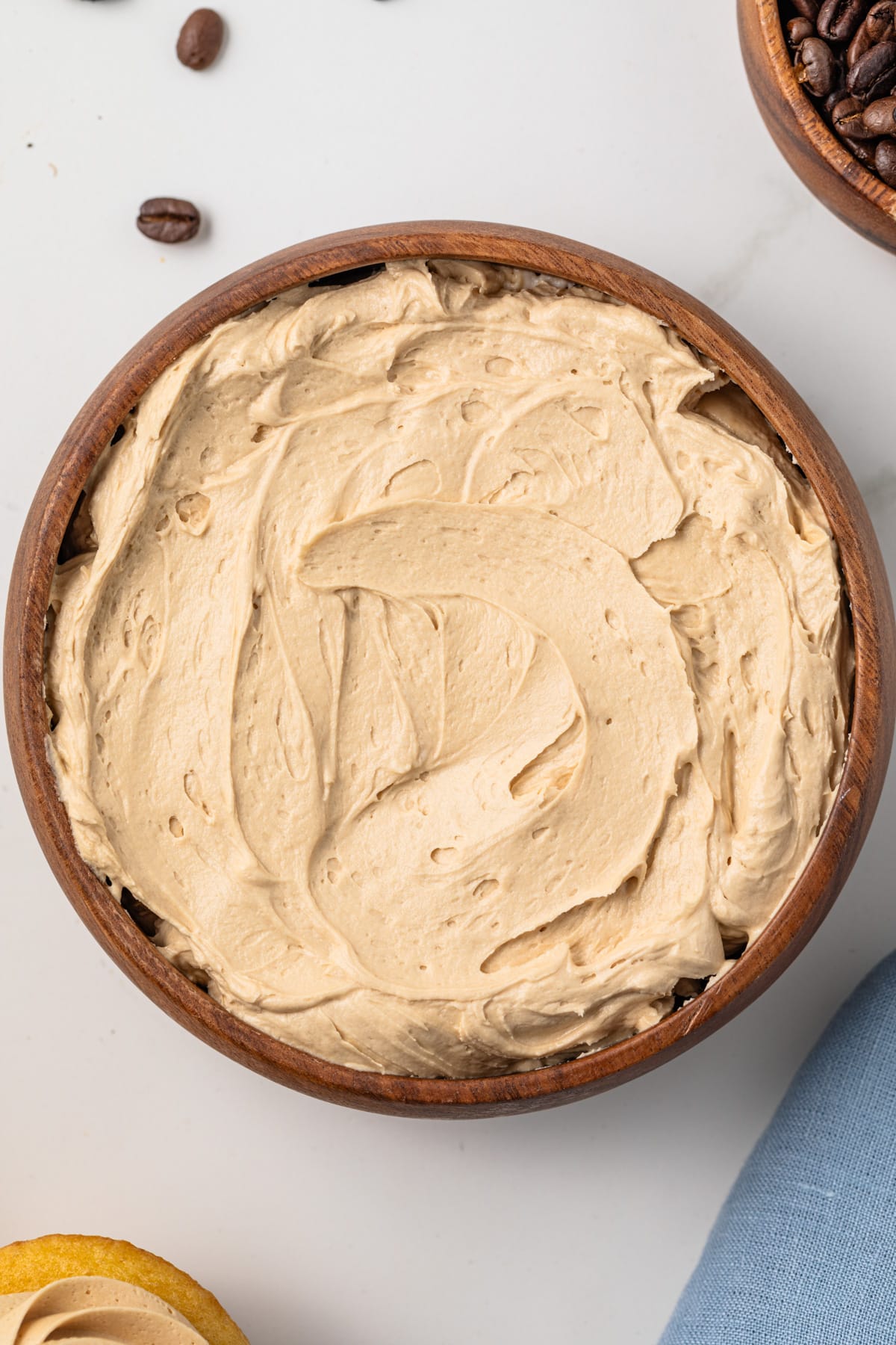 Close up of coffee frosting in a wooden bowl.