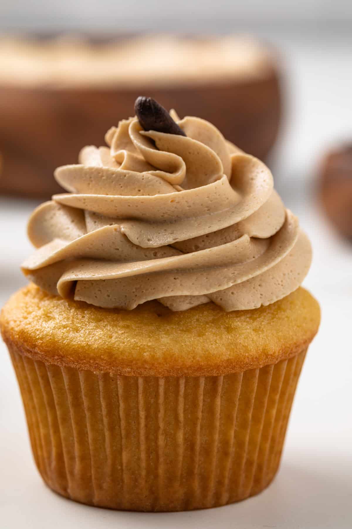 Close up of coffee frosting over a vanilla cupcakes.