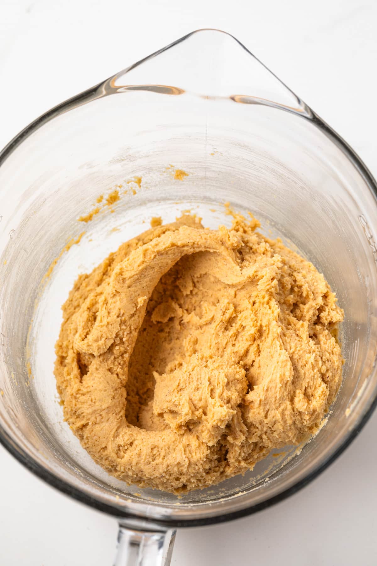 Pumpkin cookie dough in a glass bowl.