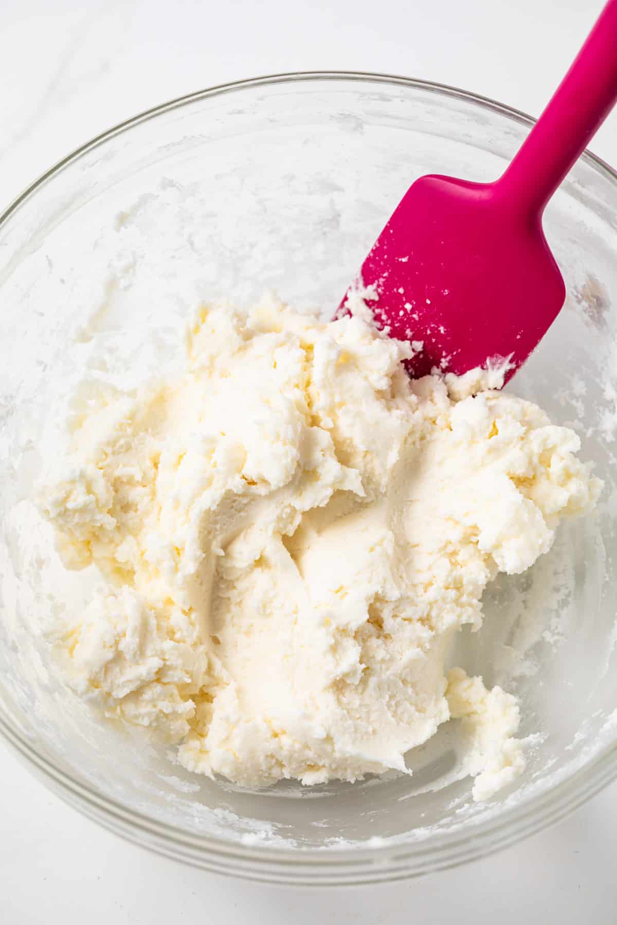 Cream cheese mint dough in a glass bowl.