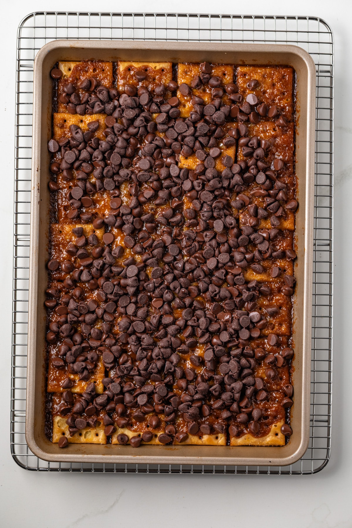 Toffee sauce and chocolate chips over crakers.