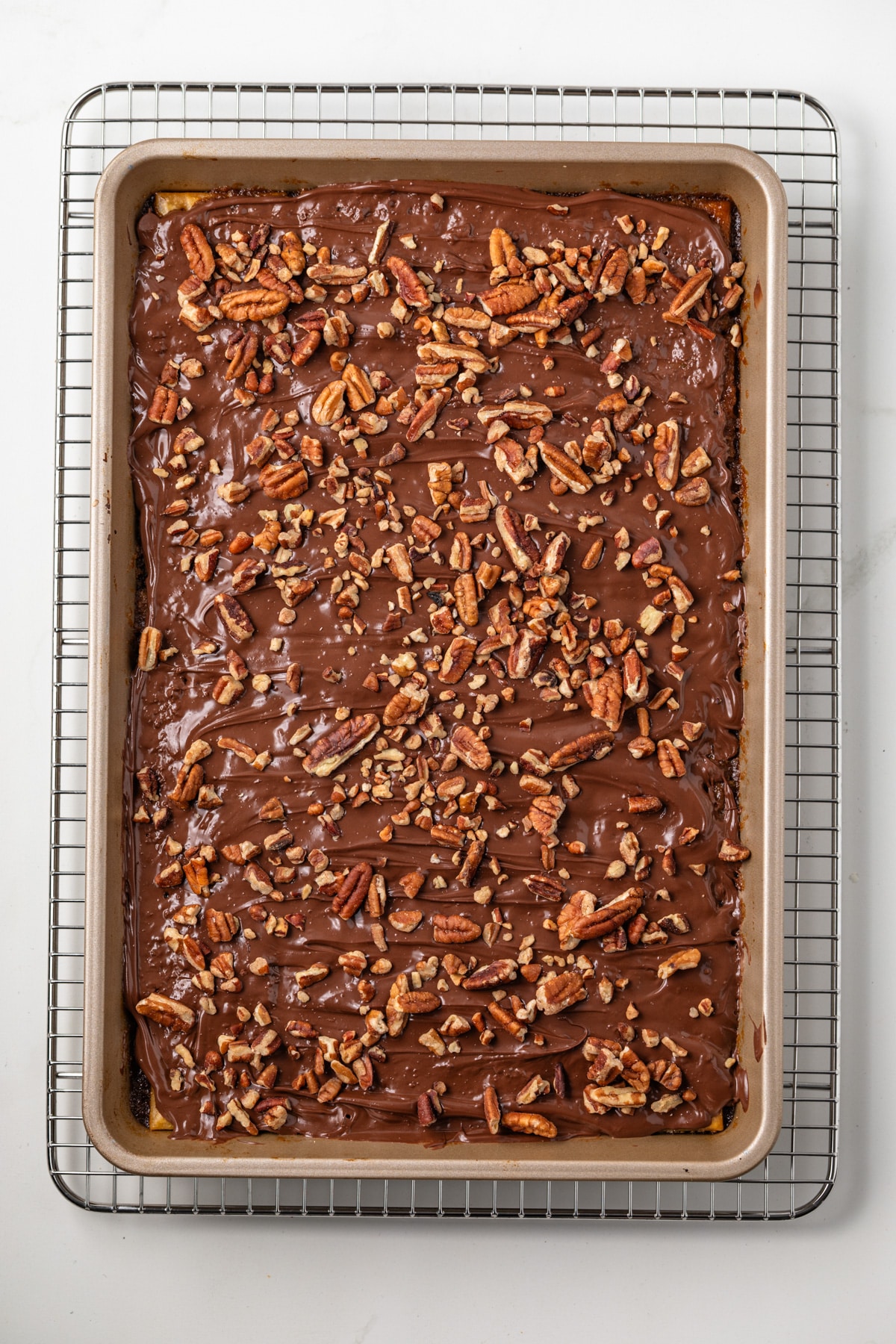 Melted chocolate over crackers topped with pecans.