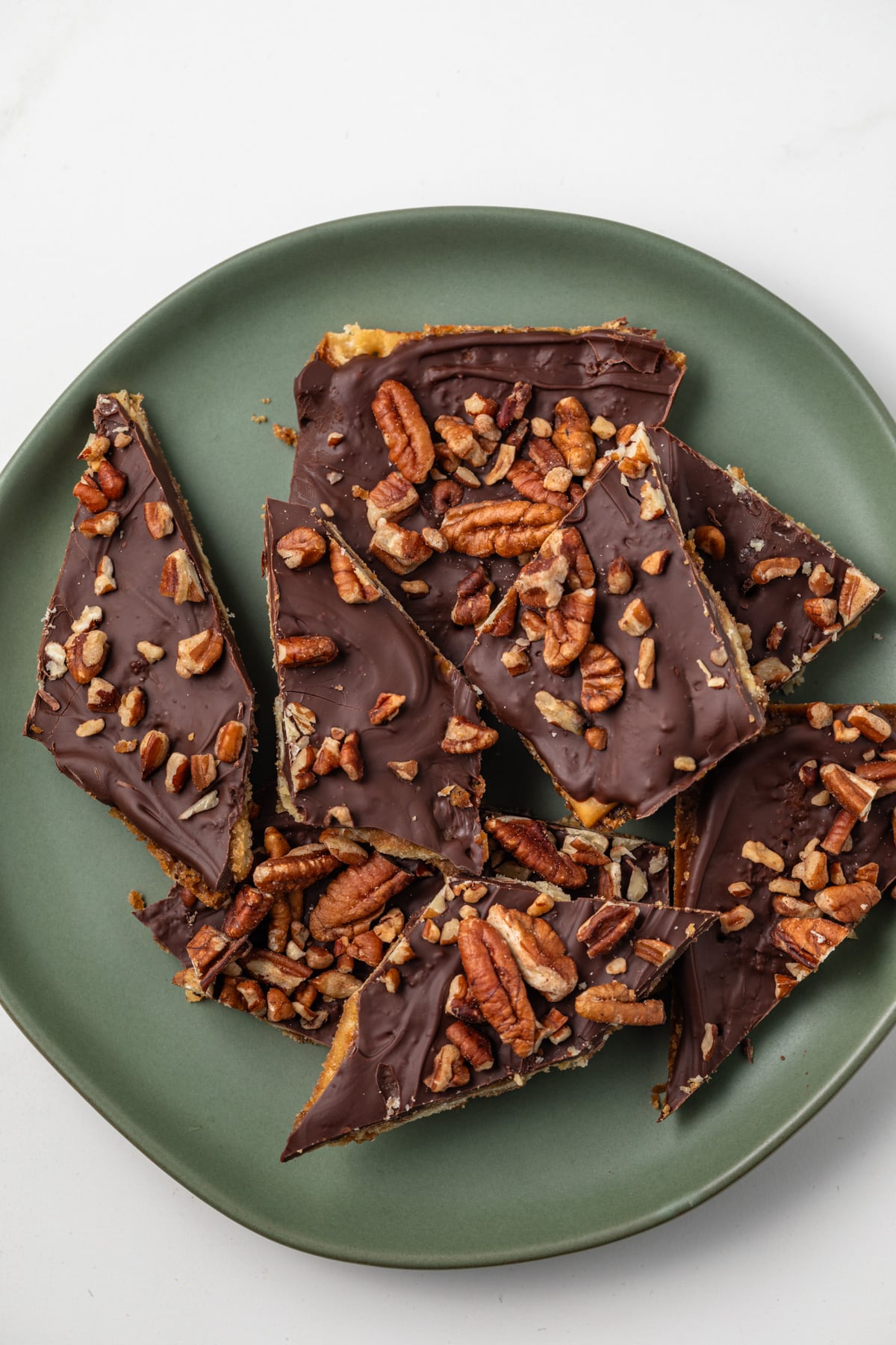 Saltine cracker toffee on a green plate.