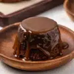 Sticky toffee pudding with a slice taken out by a fork.