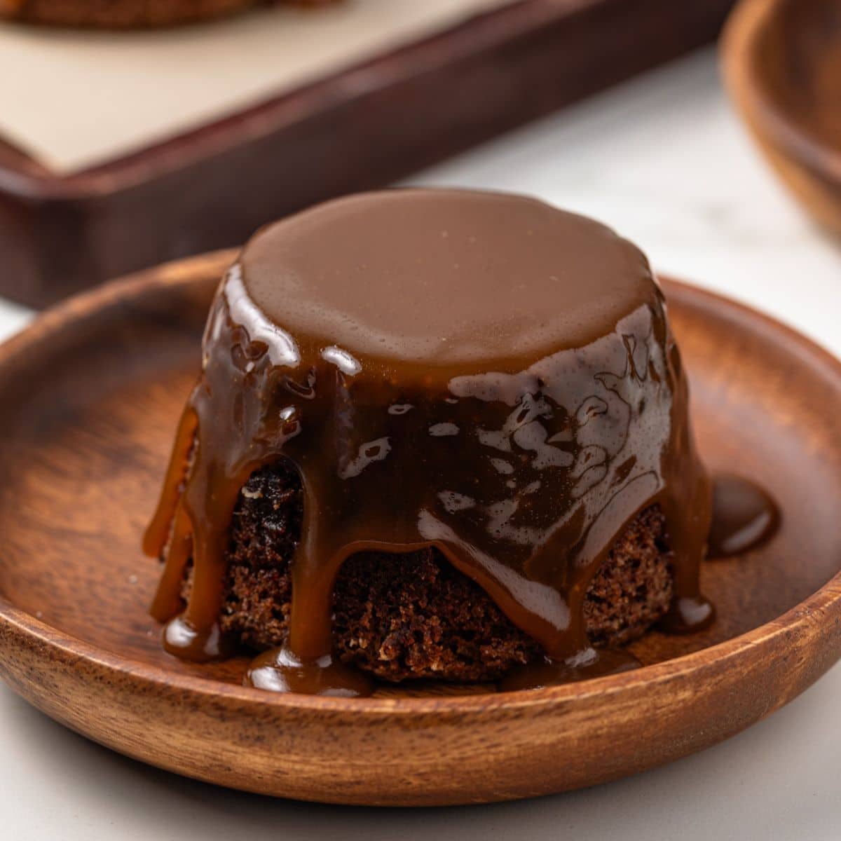 Sticky toffee pudding with a slice taken out by a fork.