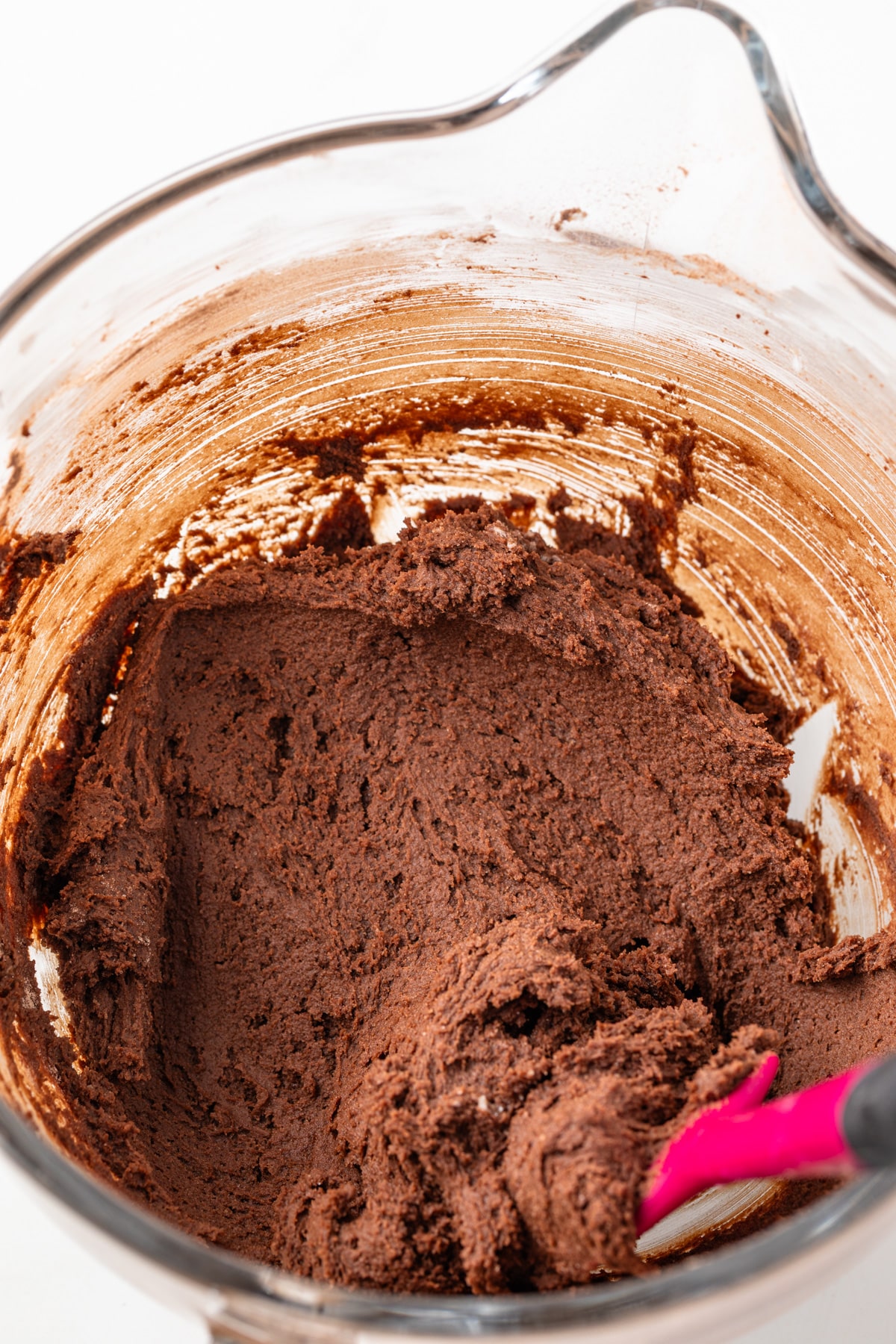 Chocolate cookie dough in a glass bowl.