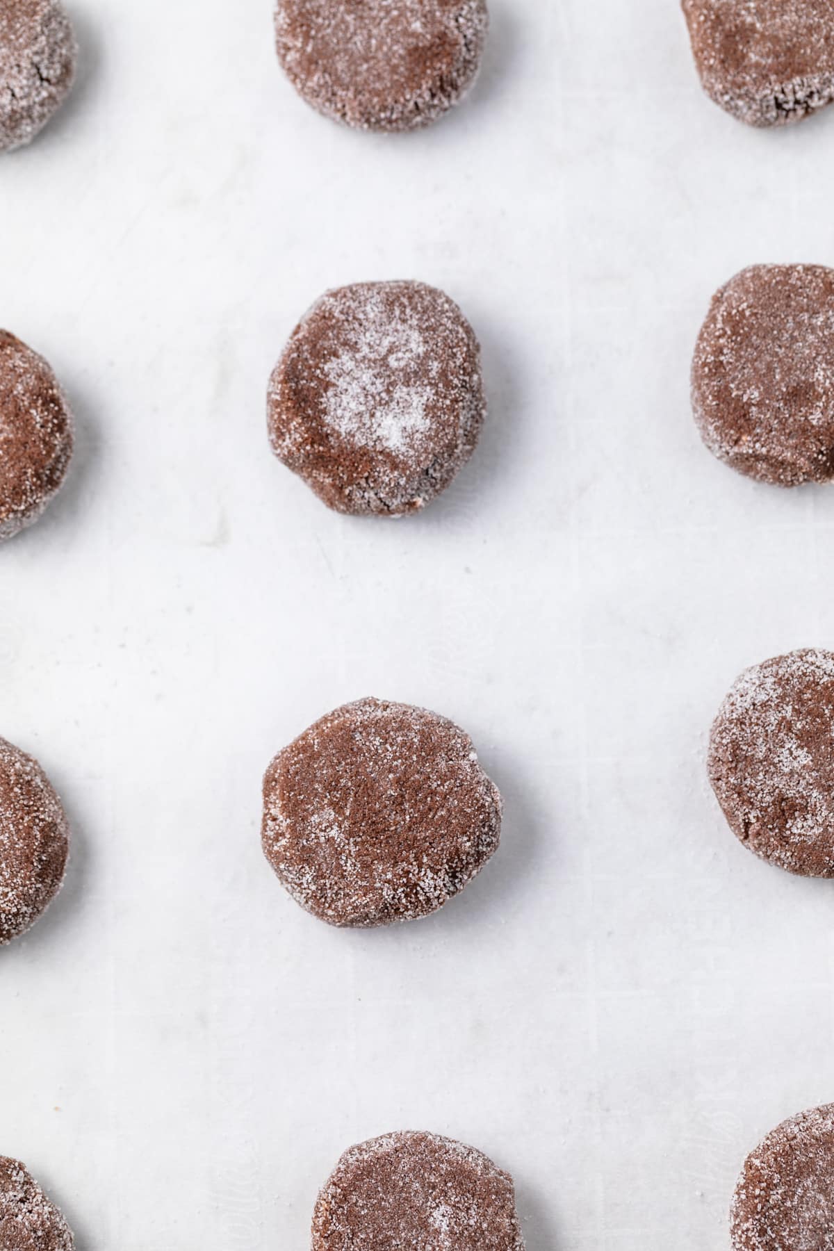Unbaked chocolate cookies on a baking sheet.