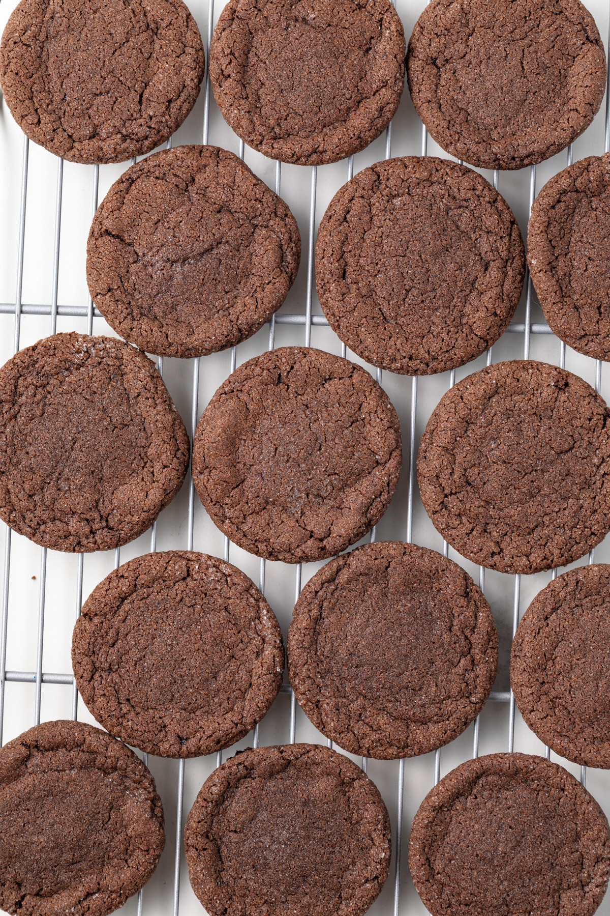 Chocolate sugar cookies on a wire rack.