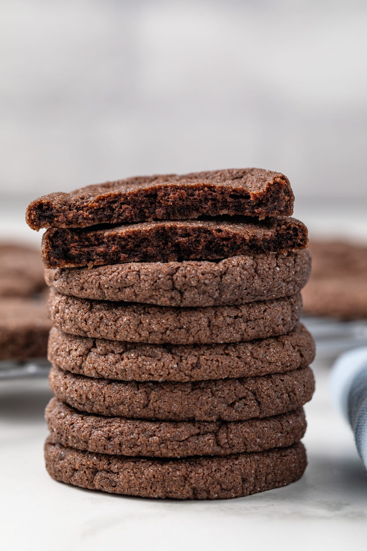 Broken chocolate sugar cookie on top of a cookie stack.