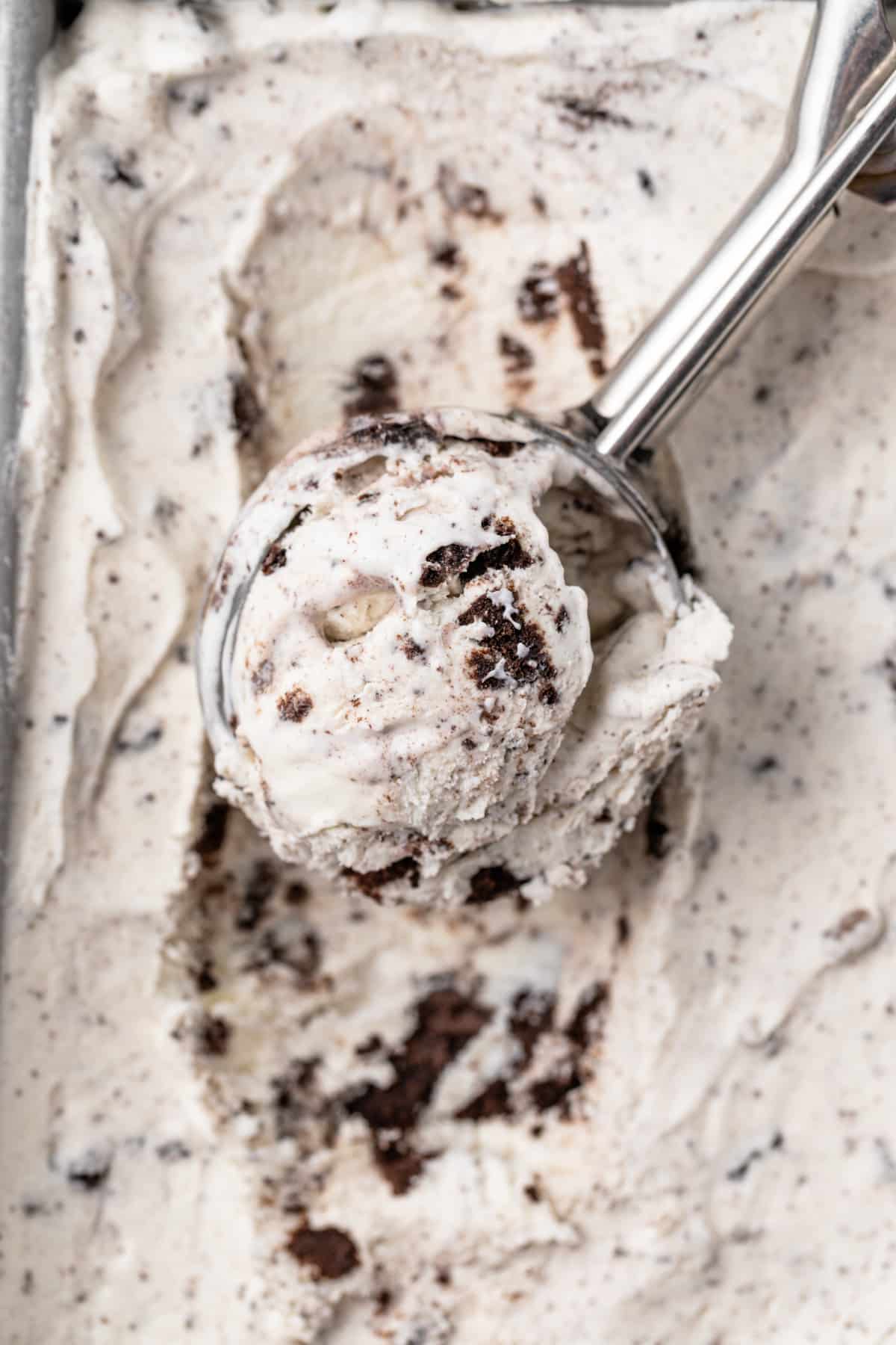 A scoop scooping out oreo ice cream.