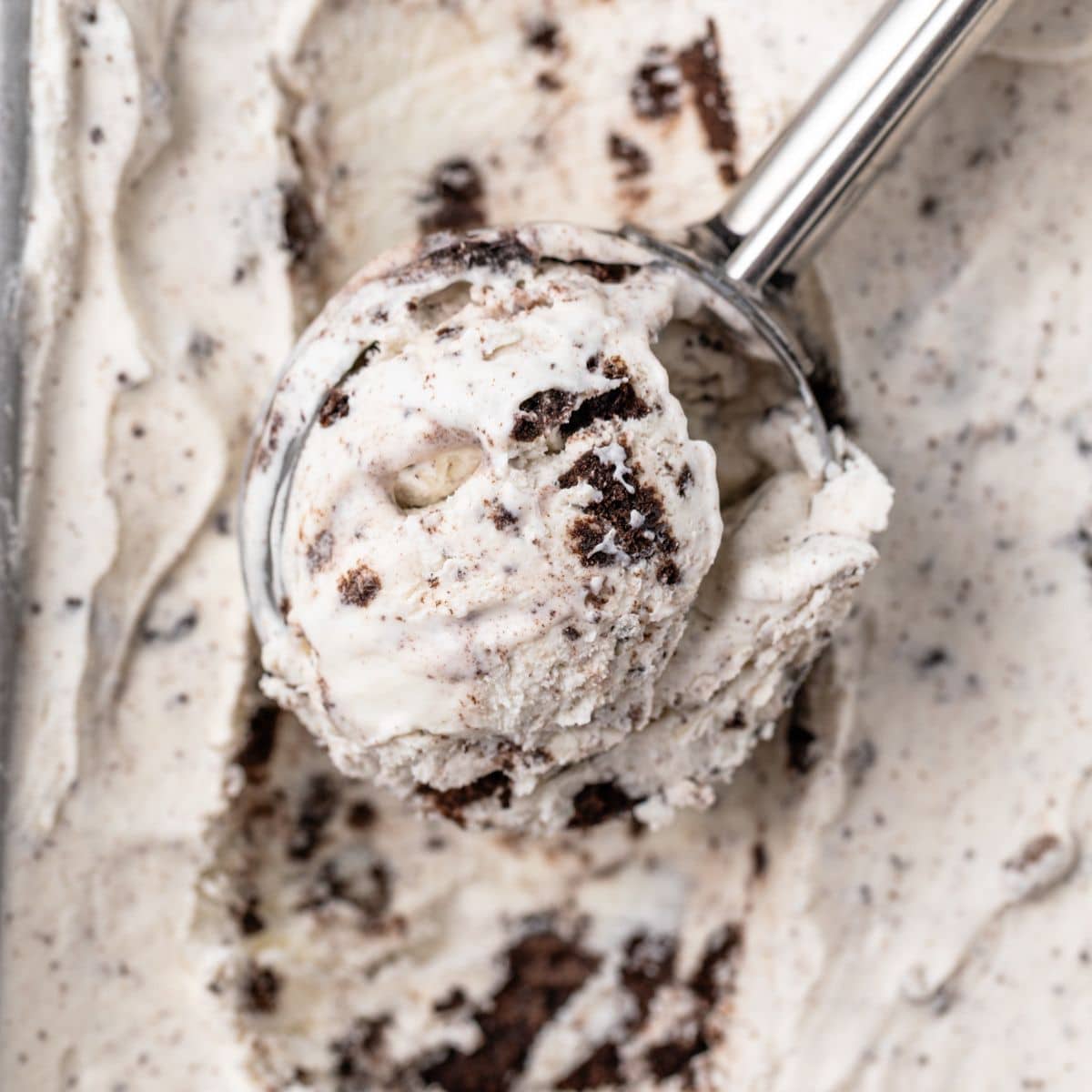 A scoop scooping out oreo ice cream.