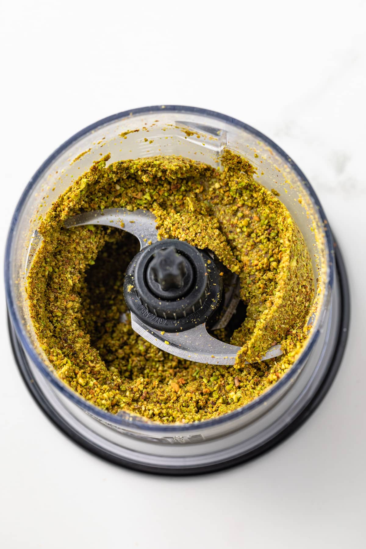 Ground pistachios in a food processor.