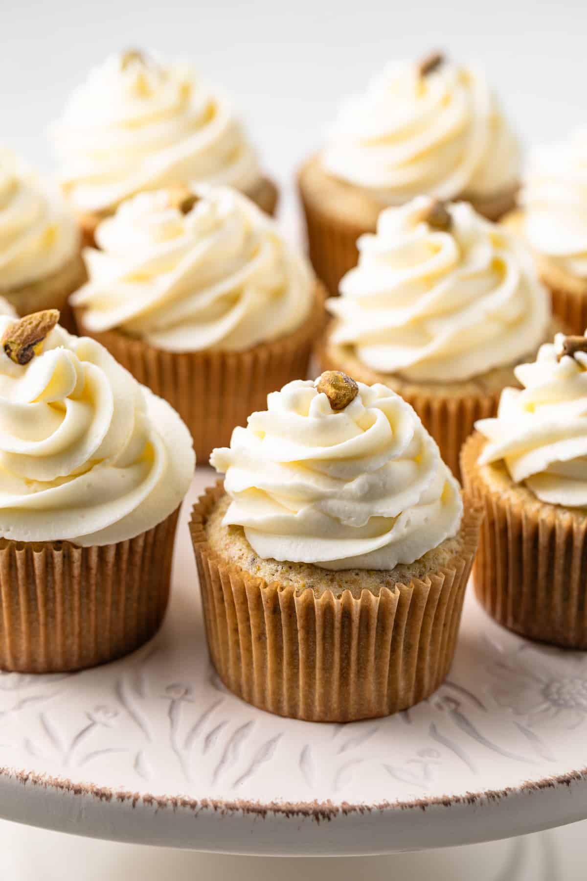 Pistachio cupcakes with whipped cream cheese frosting.