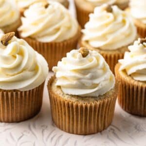 Pistachio cupcakes with whipped cream cheese frosting.