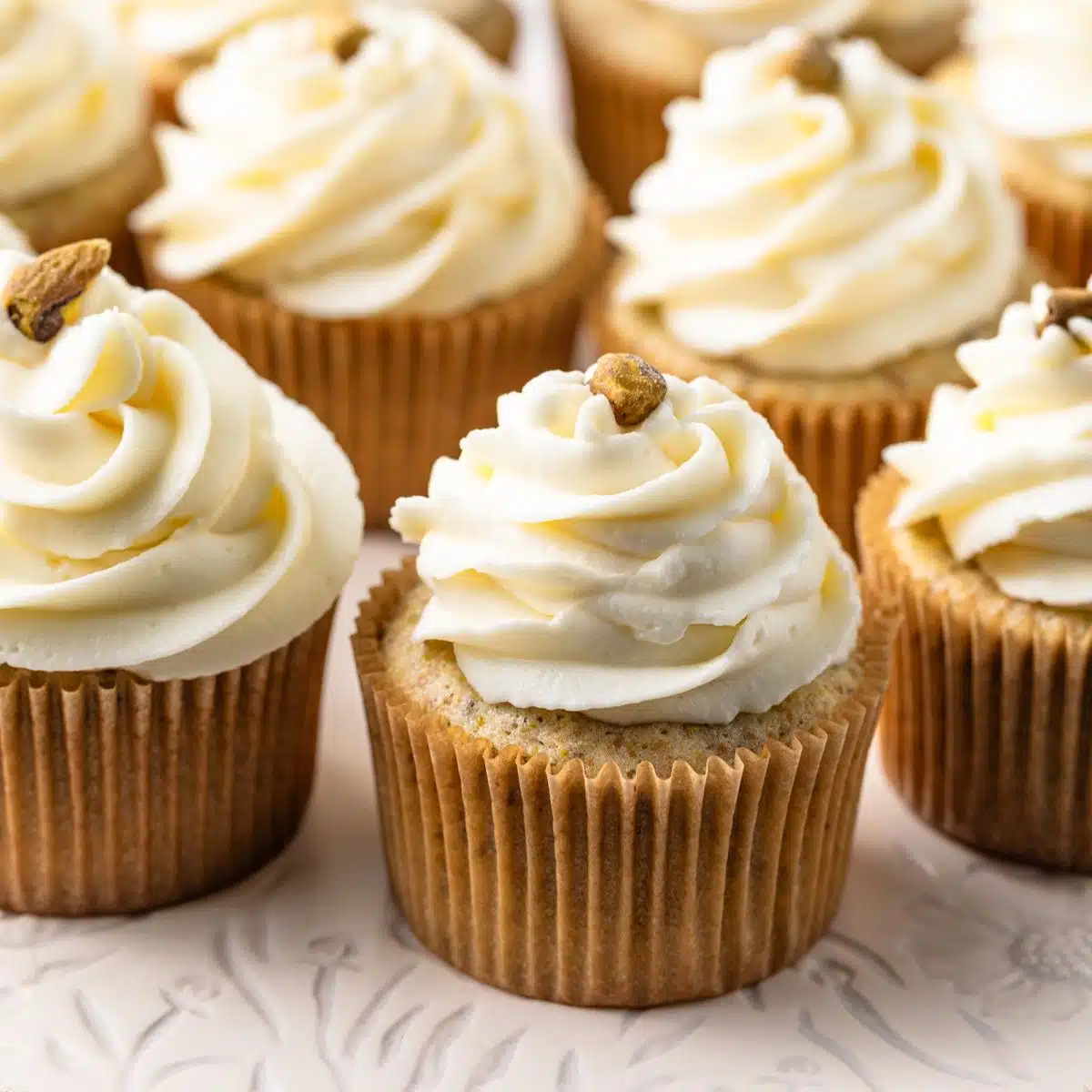 Pistachio cupcakes with whipped cream cheese frosting.