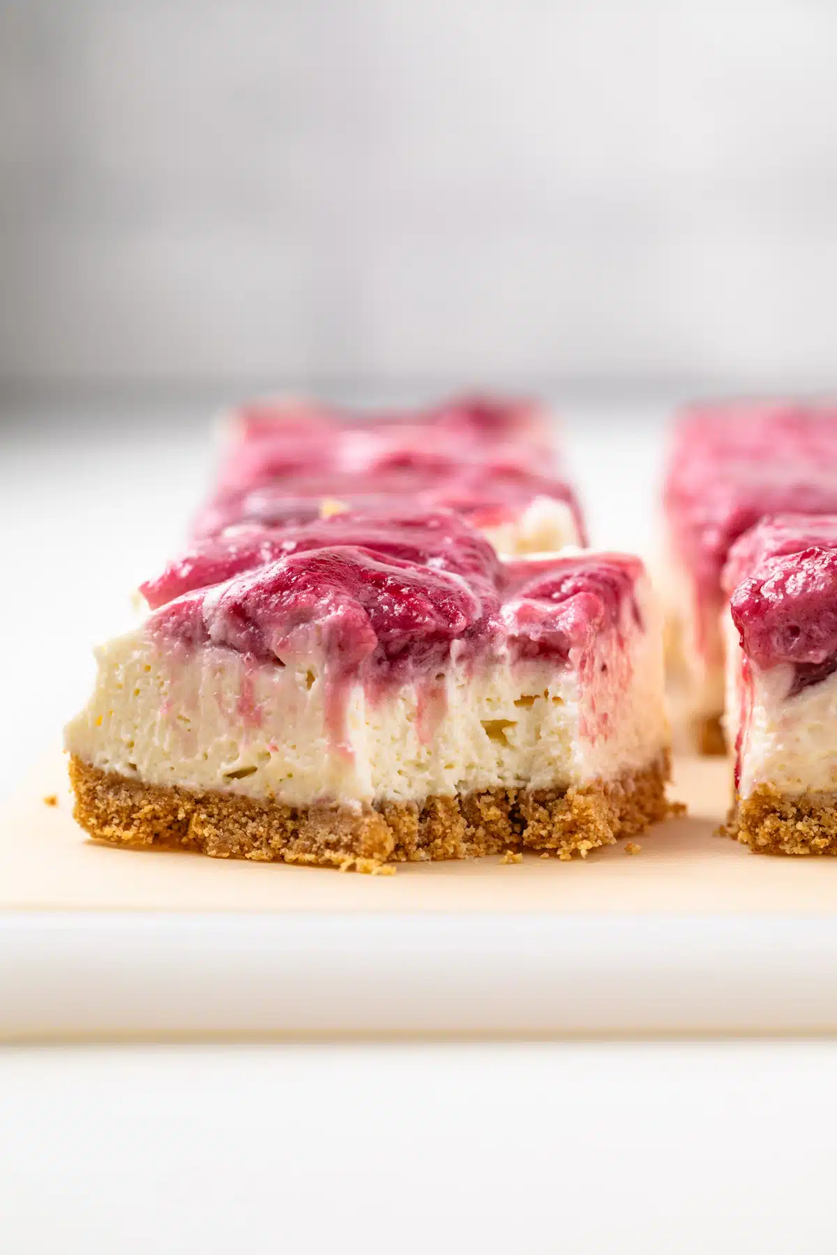 No bake berry cheesecake bar with fork bite taken out.