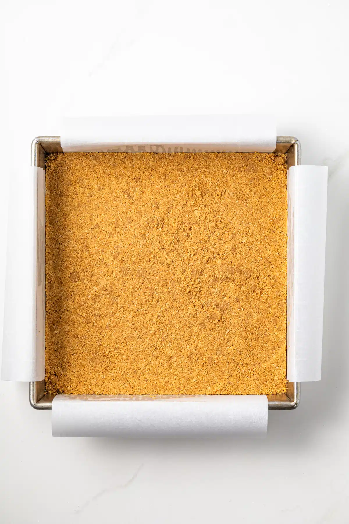 Graham cracker crust in a pan.