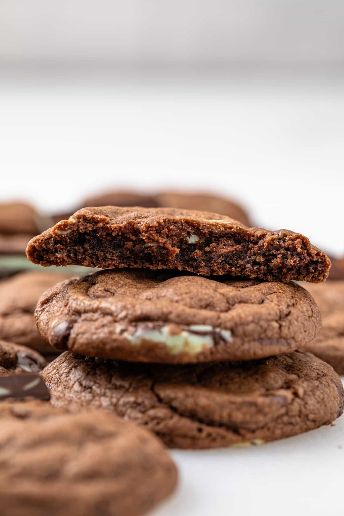 Andes mint cookies stacked with the top one broken.