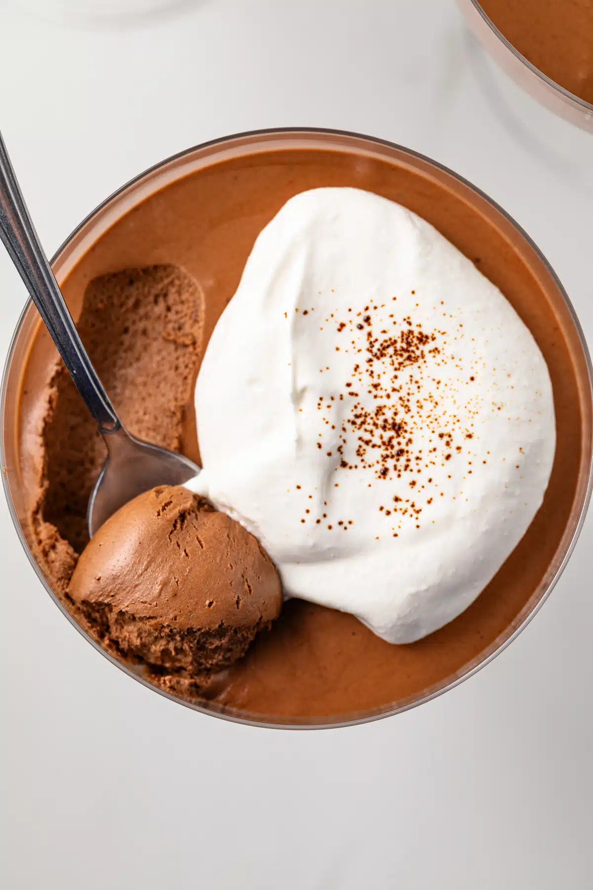A spoon scooping out a bite of chocolate coffee mousse.