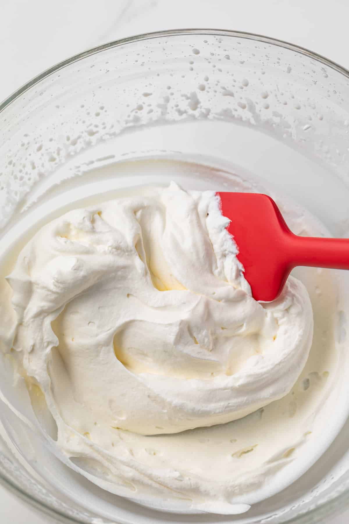 Whipped cream in a glass bowl.