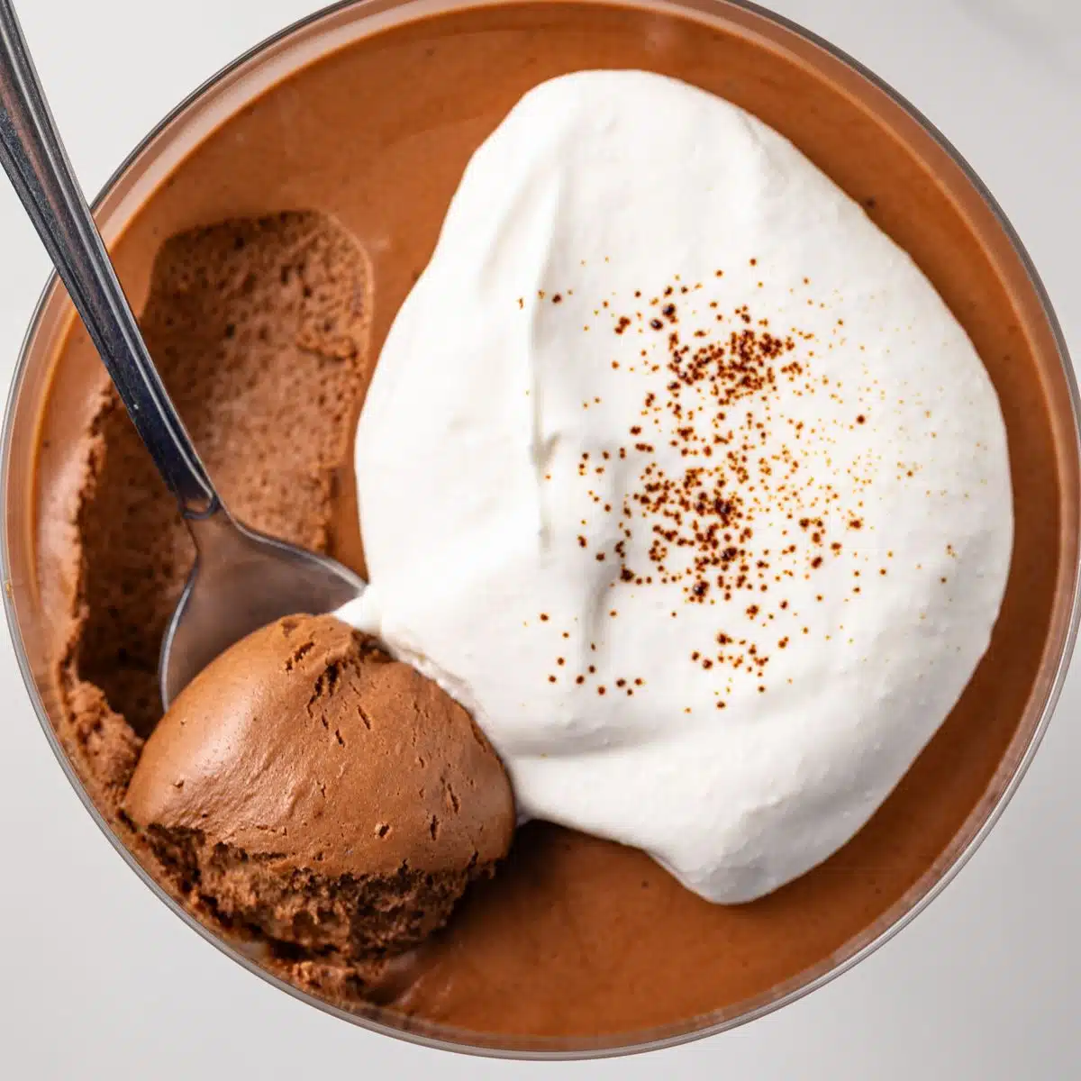 A spoon scooping out a bite of chocolate coffee mousse.