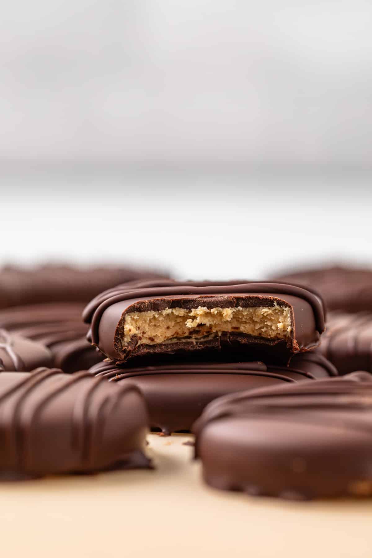 Bite taken out of a peanut butter egg so the filling is visible.