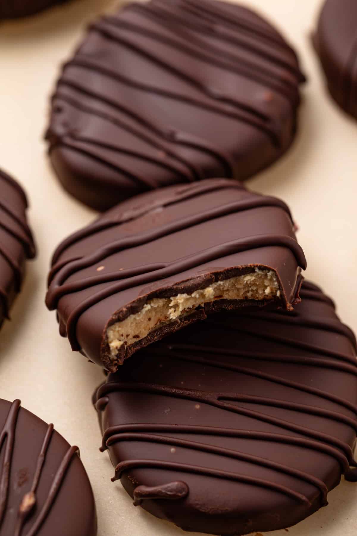 Peanut butter eggs with a bite taken out of one.