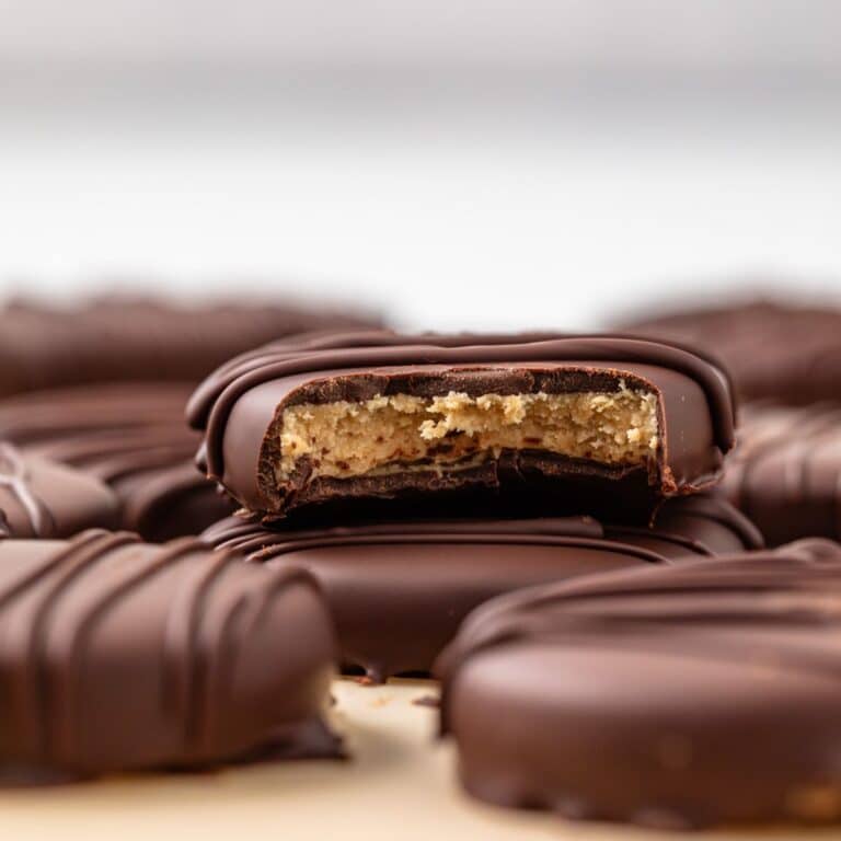 Bite taken out of a peanut butter egg so the filling is visible.