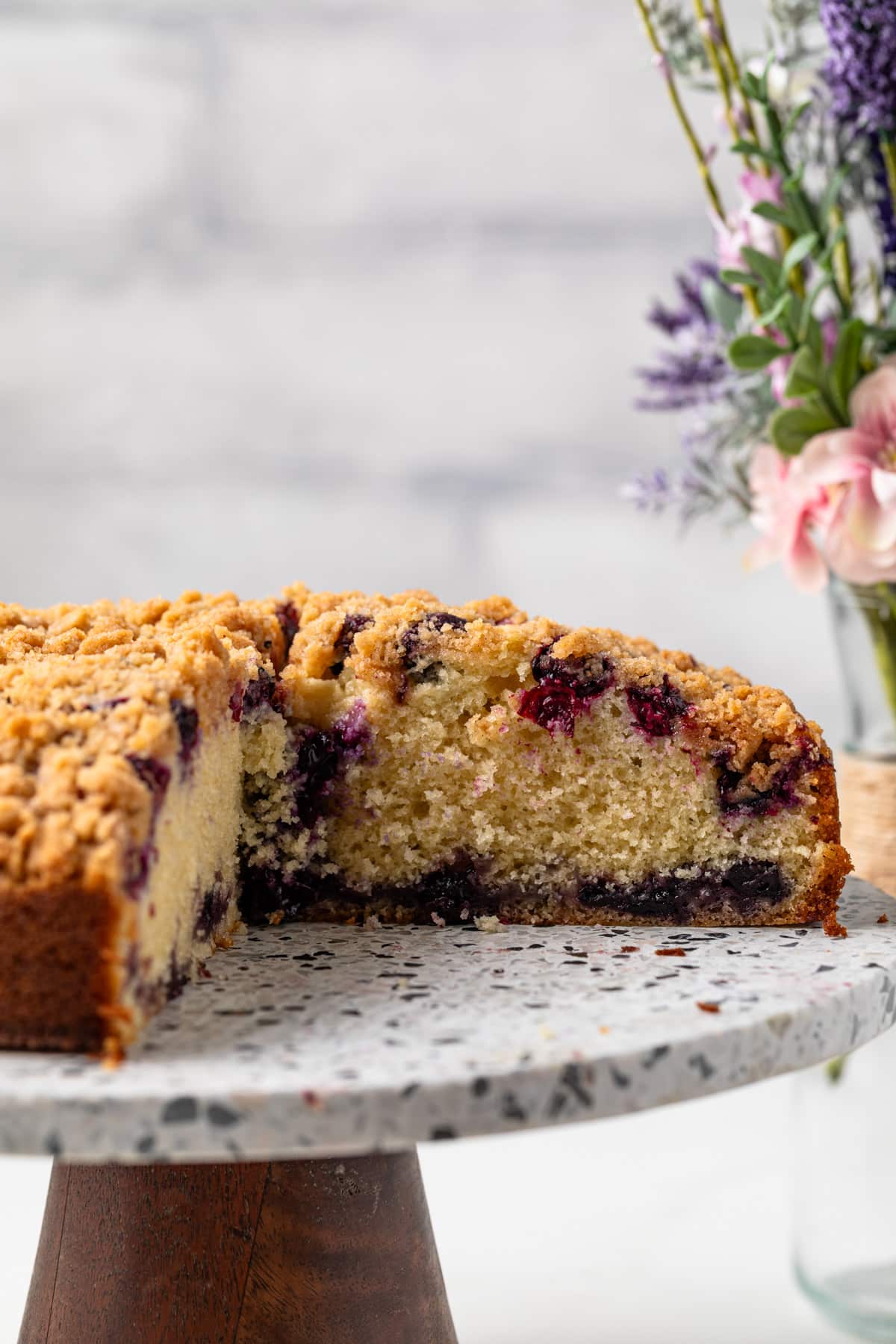 Blueberry coffee cake with a slice taken out.