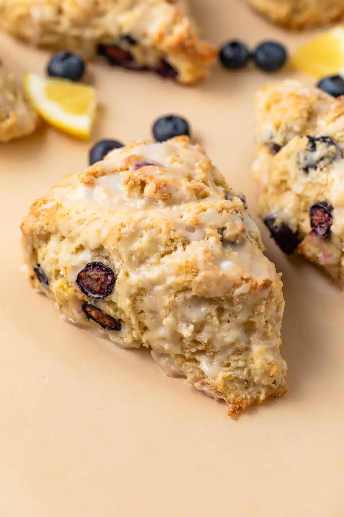 High angled view of lemon blueberry scone with lemon drizzle.