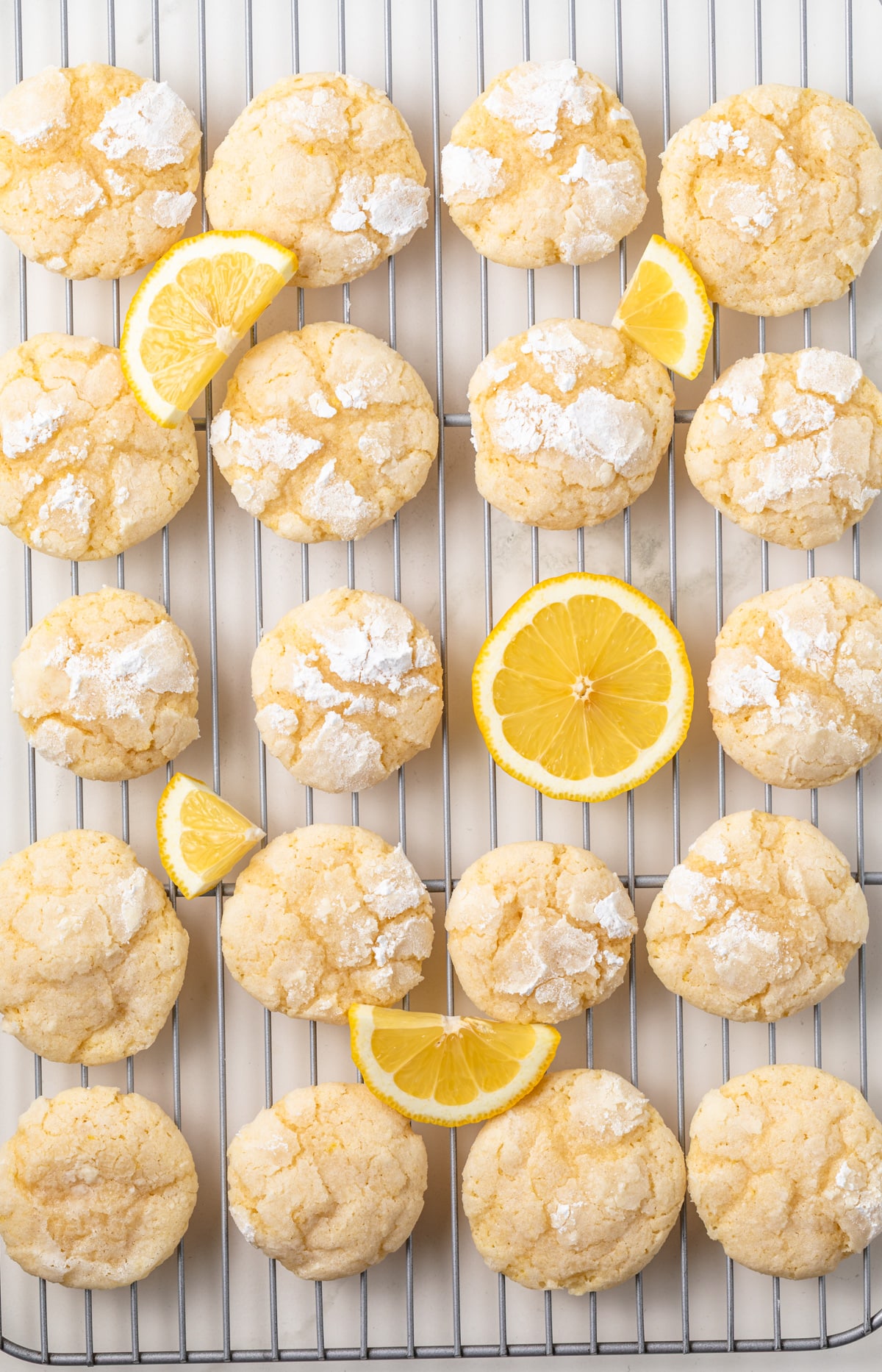 Lemon crinkle cookies in a wire rack.