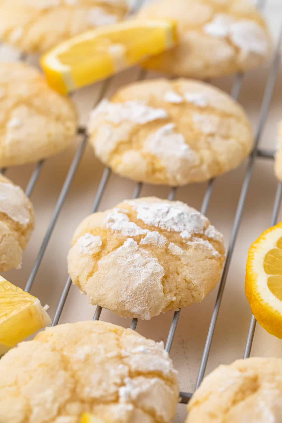 Side view of lemon crinkle cookies on wire rack.