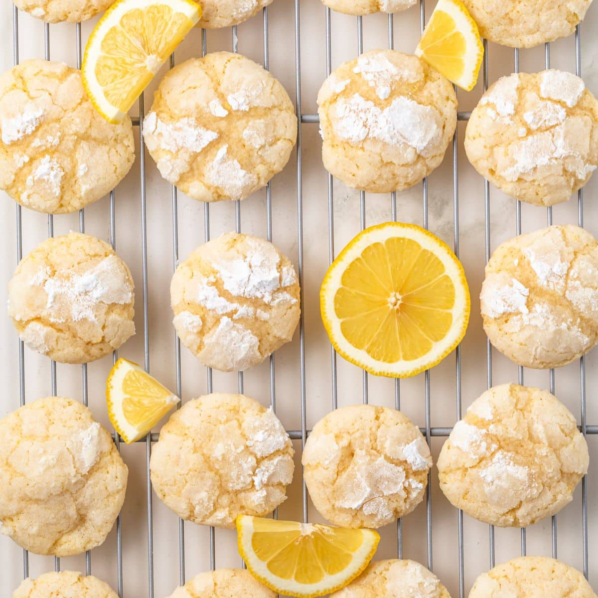 Lemon crinkle cookies in a wire rack.