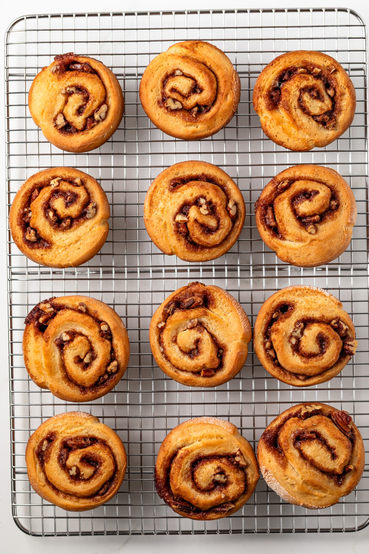 Pecan rolls on a wire rack.
